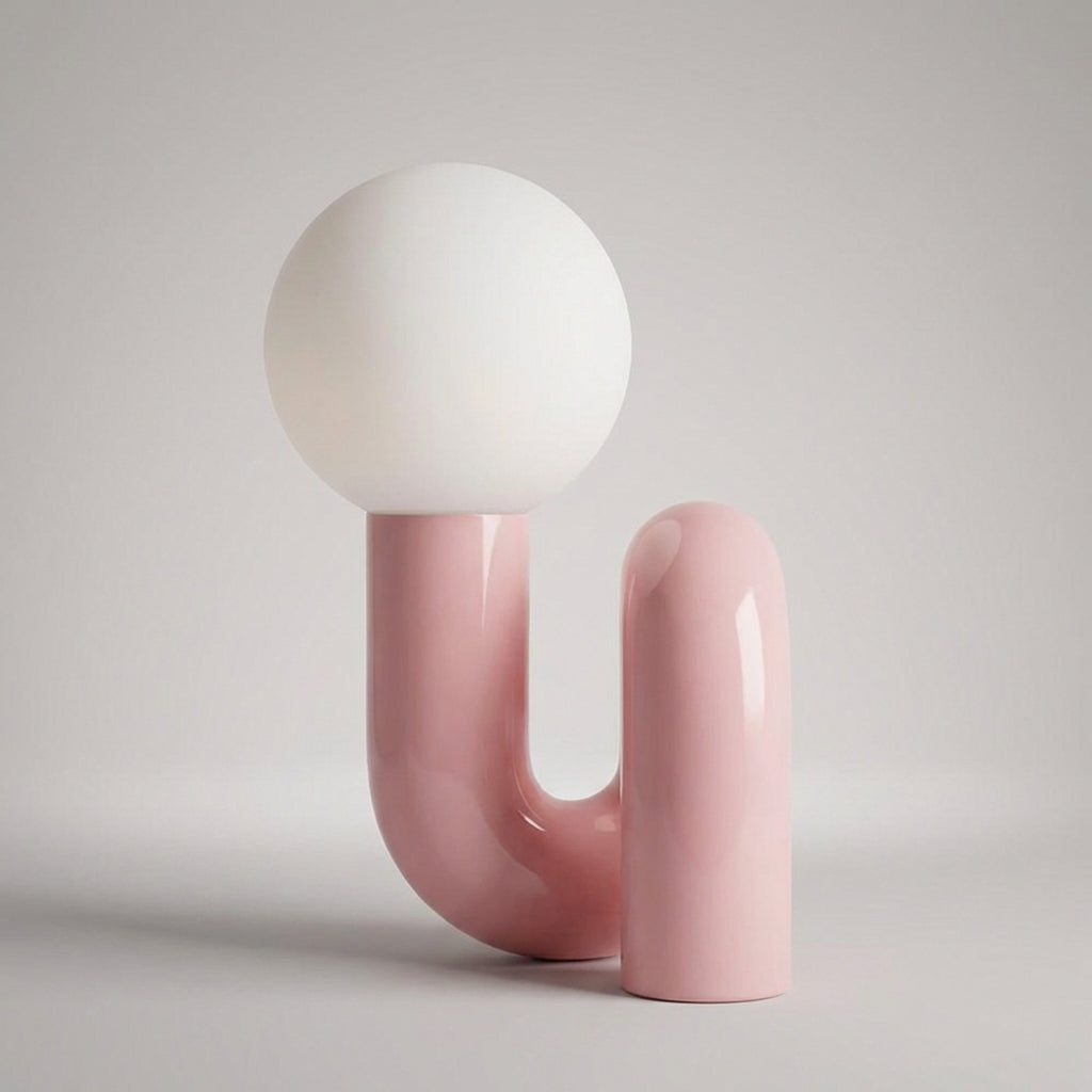 Lámpara de mesa escultural con base de resina y globo de vidrio esmerilado