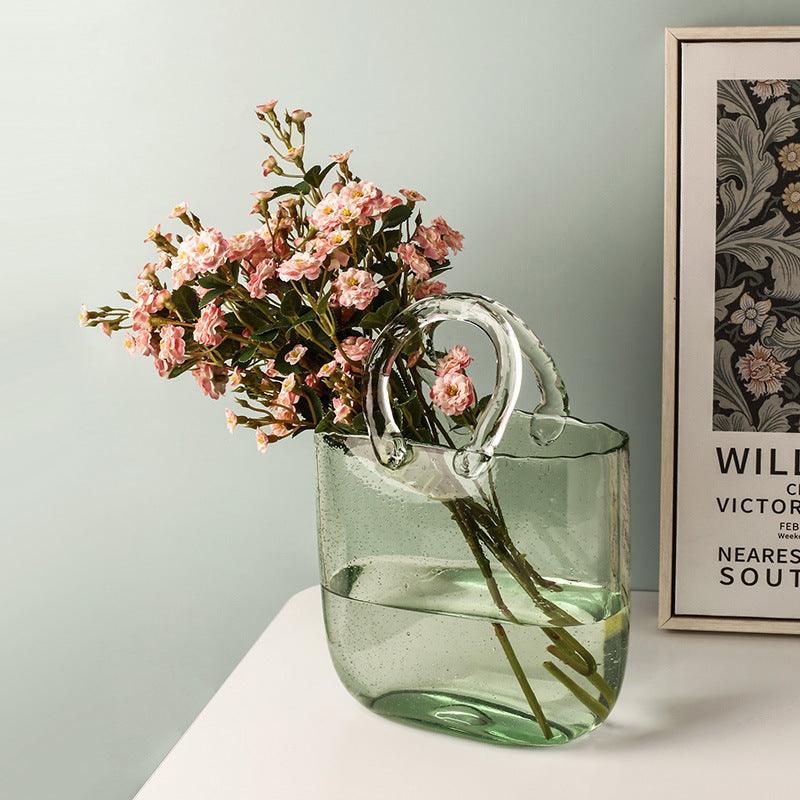Jarrón decorativo de flores de vidrio transparente con silueta escultórica de bolso