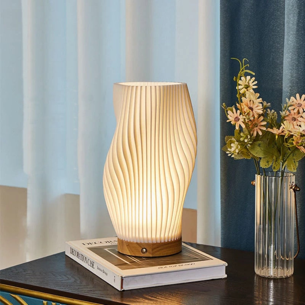 Lámpara de mesa regulable con pantalla esculpida en forma de onda y base de madera