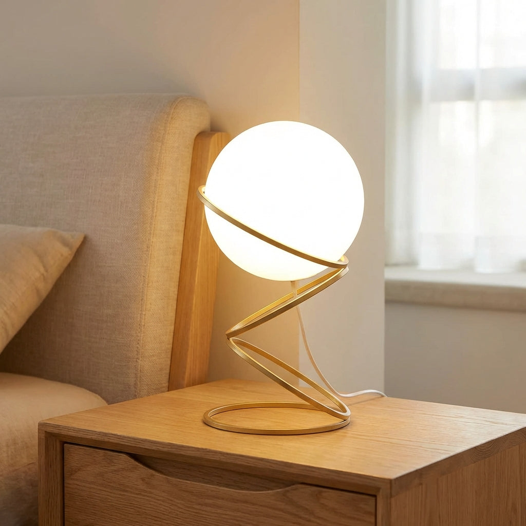 Lámpara de mesa escultural con base metálica en espiral y esfera de acrílico redonda