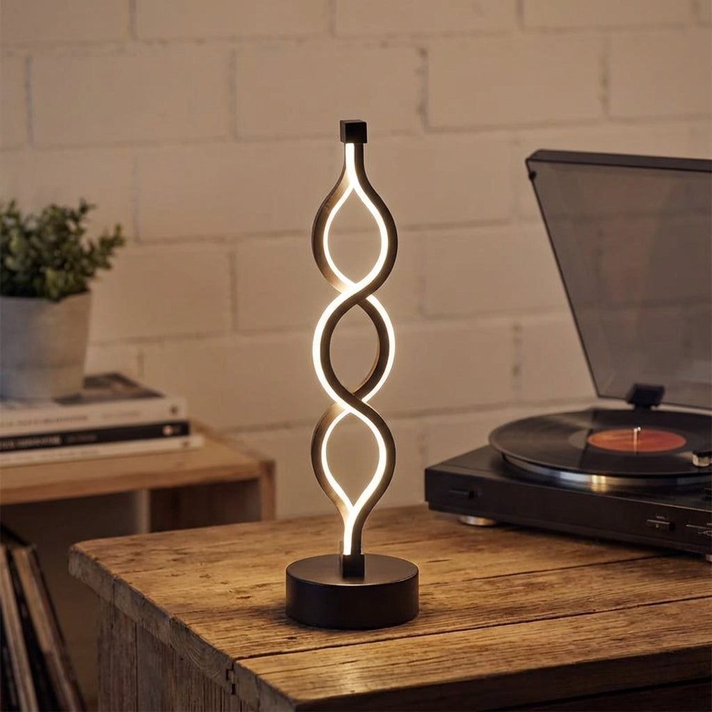 Lámpara de mesa compacta con silueta de espiral escultural y luz cálida