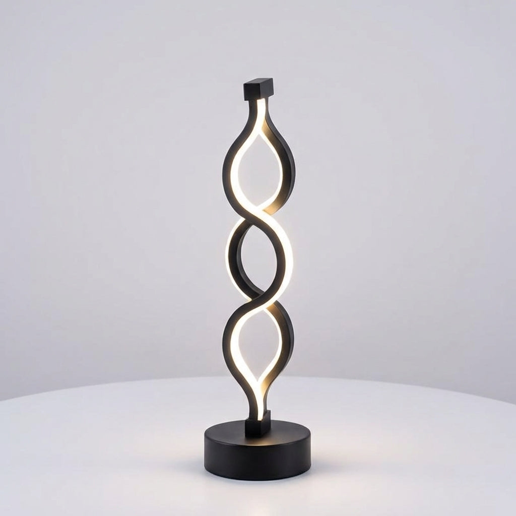 Lámpara de mesa compacta con silueta de espiral escultural y luz cálida