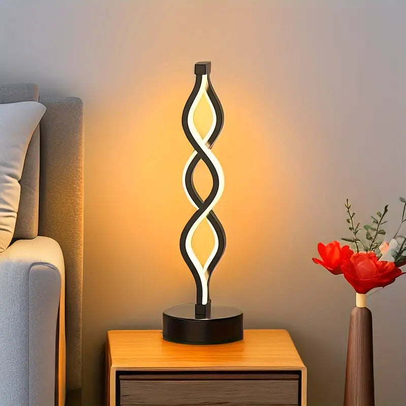 Lámpara de mesa compacta con silueta de espiral escultural y luz cálida